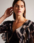JASMYNA-Tops-Ruffled to perfection and finished with a bow, JASMYNA is your ticket to style heaven. Bottomless brunch? More like your own personal catwalk.The fabric of this product is made of 100% recycled polyester. Using recycled polyester helps divert plastic waste from ending in landfills and helps us to reduce our dependancy on virgin materials. Ruffled top V-neck Abstract print Short sleeved Low back with tie fastening and zip Amy is 5'9.5" / 1.77m and wears Black in a Ted size 1- Ted Baker Romania